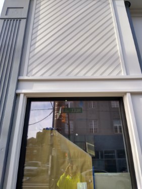 right side of store front with finished paint coat